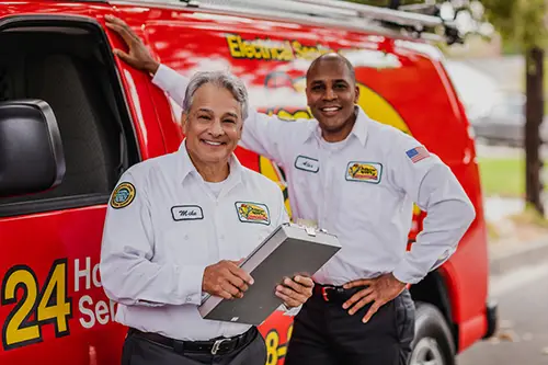 Mister Sparky Technicians standing outside of a van in front of a house in Clearwater